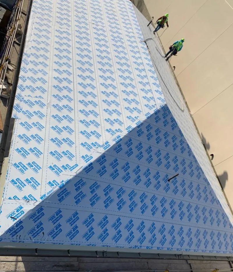 Professional roofers installing underlayment on a metal roof in Hawaiian Gardens